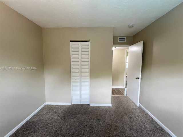 unfurnished bedroom featuring a closet and carpet