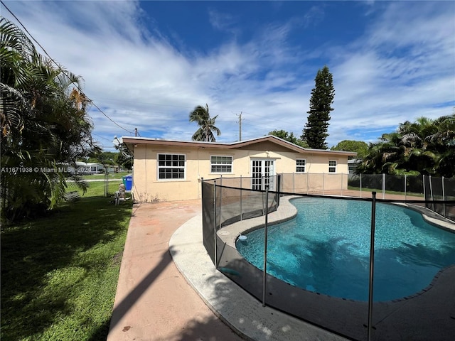 view of swimming pool with a lawn and a patio area