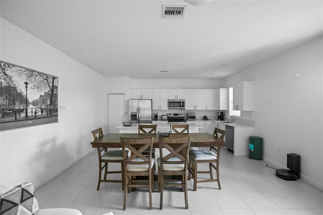 dining room with light tile patterned flooring and sink