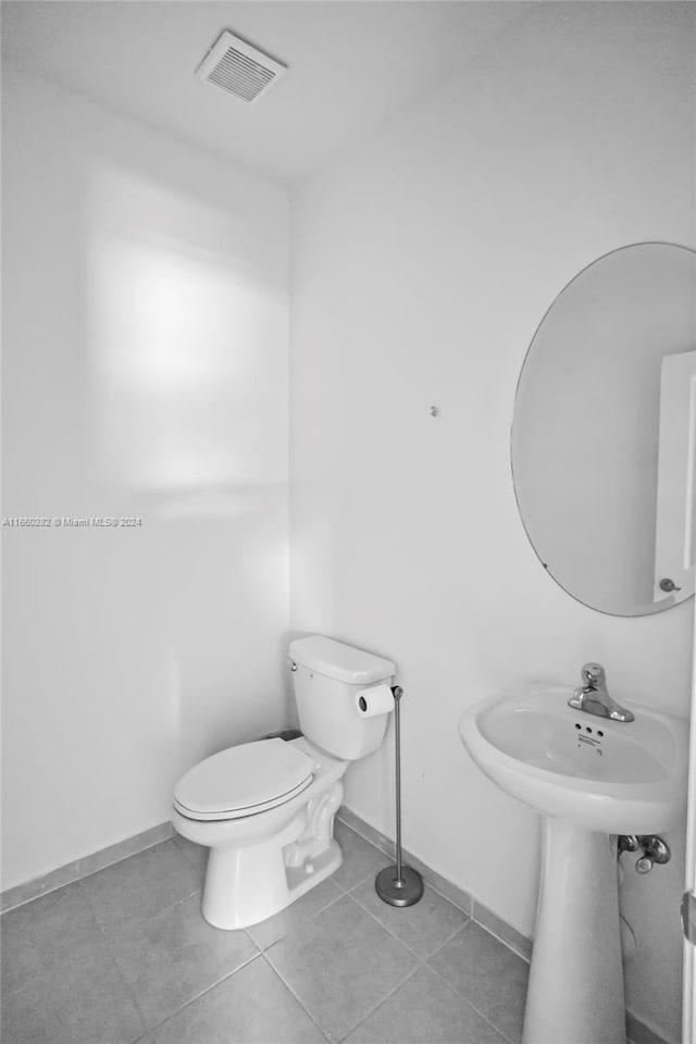 bathroom with tile patterned flooring and toilet