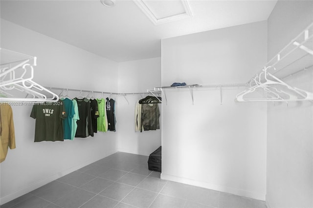 spacious closet with tile patterned floors