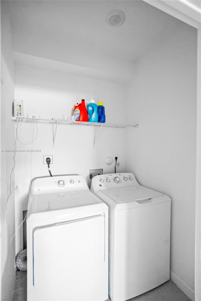 laundry room with tile patterned flooring and washer and dryer