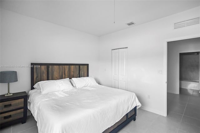 tiled bedroom featuring a closet