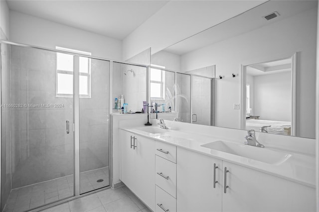 bathroom featuring walk in shower, vanity, and tile patterned floors