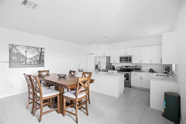 tiled dining area featuring sink