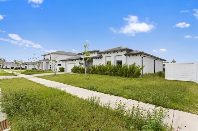 view of property exterior with a garage and a yard