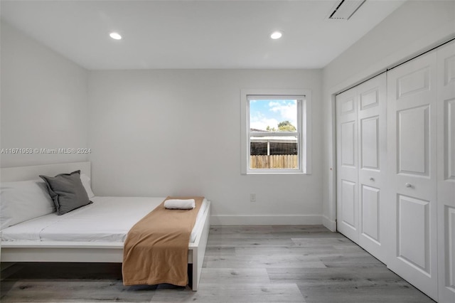 bedroom with a closet and light hardwood / wood-style floors