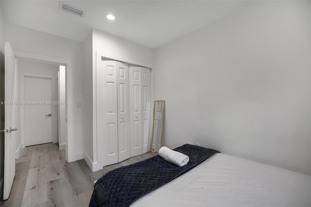 bedroom featuring a closet and light hardwood / wood-style flooring