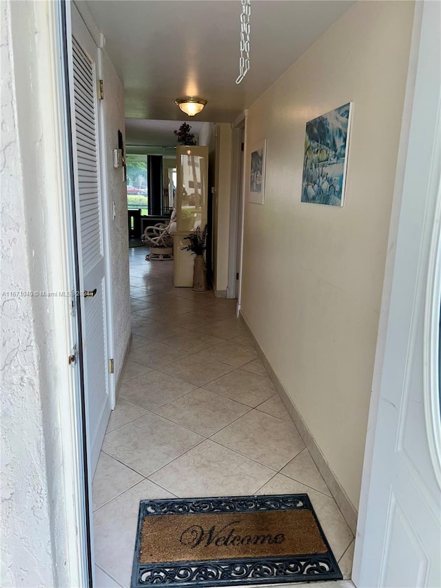 corridor featuring light tile patterned floors