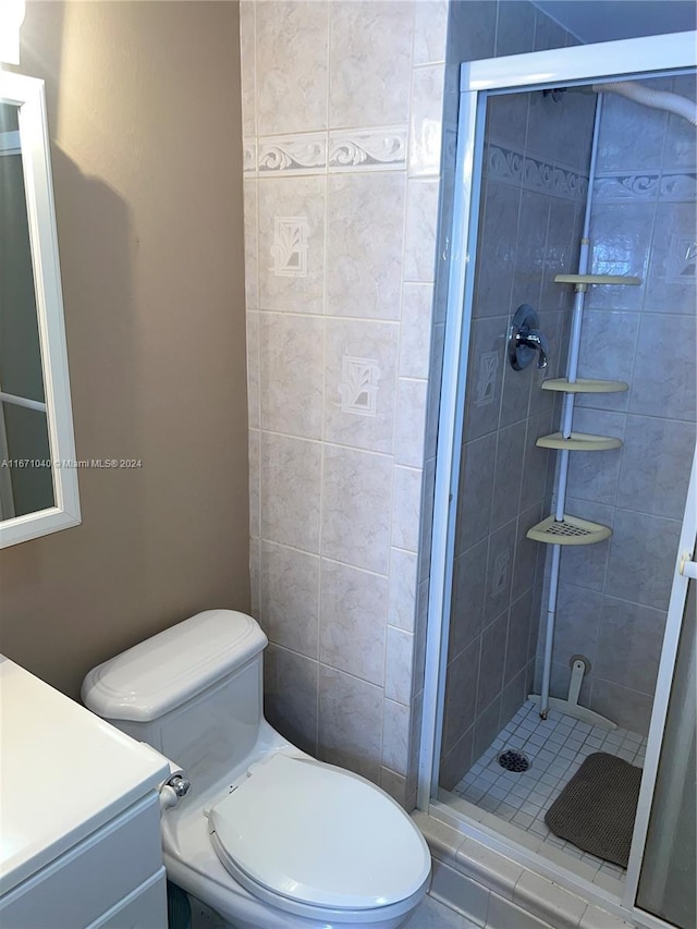 bathroom featuring walk in shower, vanity, and toilet