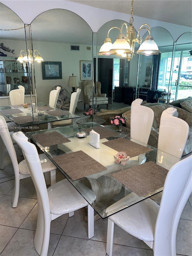 dining room featuring a notable chandelier and tile patterned floors