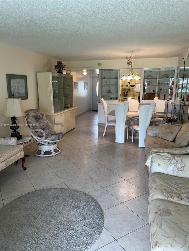 tiled living room with a chandelier and a textured ceiling