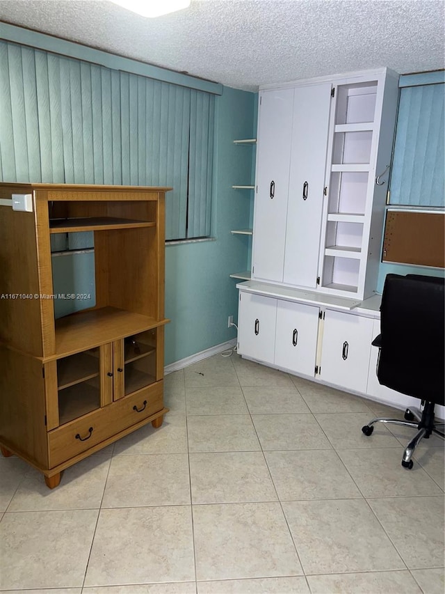 tiled office featuring a textured ceiling