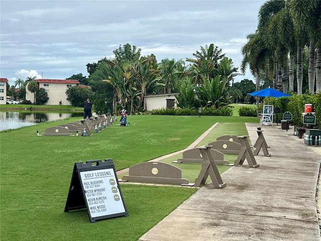 view of home's community with a yard and a water view