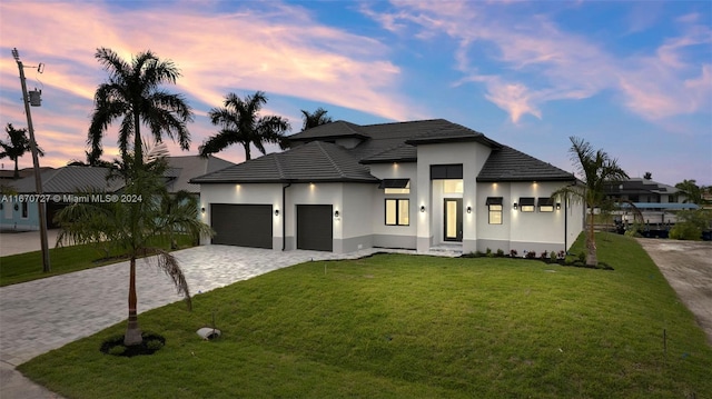 view of front of house featuring a garage and a yard