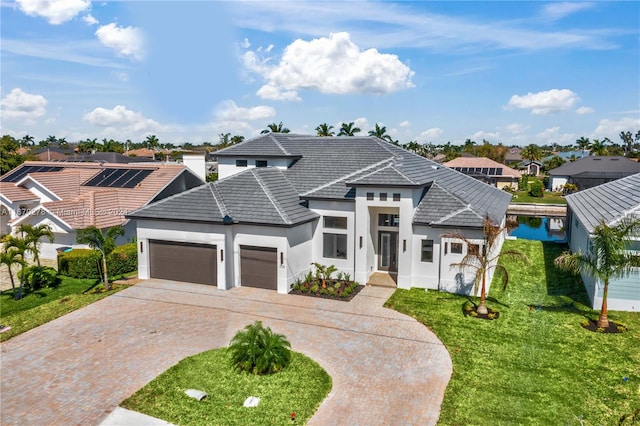 view of front of home featuring a garage and a front lawn