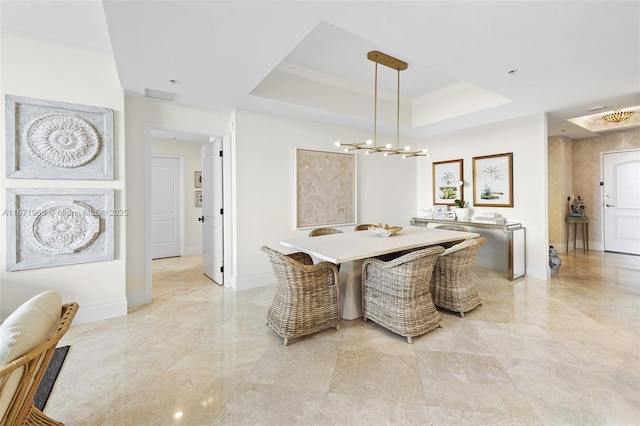 dining area with a tray ceiling, baseboards, a chandelier, and crown molding