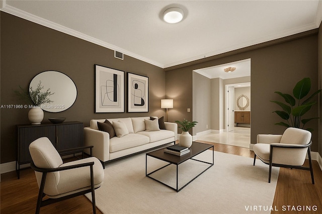 living room with baseboards, visible vents, ornamental molding, and wood finished floors