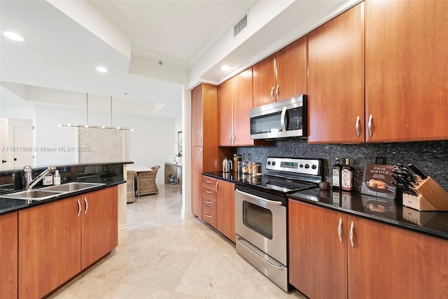 kitchen featuring sink, decorative backsplash, dark stone counters, and appliances with stainless steel finishes