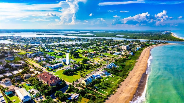 bird's eye view with a water view and a beach view