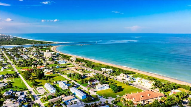 drone / aerial view featuring a water view and a view of the beach