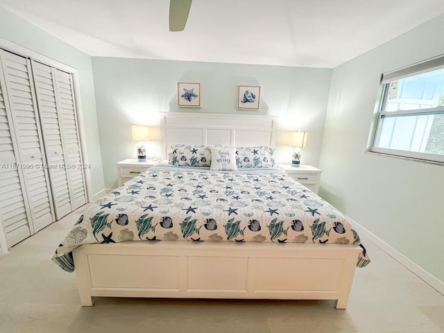 carpeted bedroom with a closet and ceiling fan