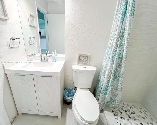 bathroom with vanity, a shower with curtain, toilet, and tile patterned floors