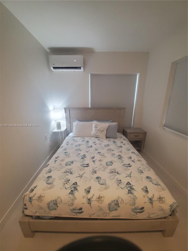 unfurnished bedroom featuring a wall unit AC