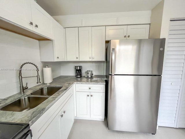 kitchen featuring stainless steel appliances, sink, and white cabinets