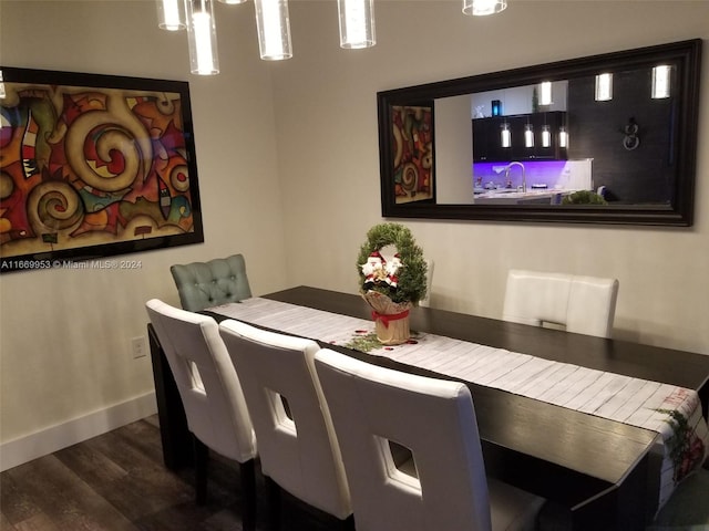 dining room with dark wood-type flooring and baseboards