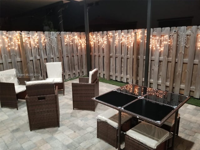 view of patio with an outdoor living space and fence