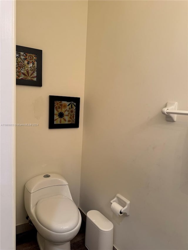 bathroom with baseboards and toilet