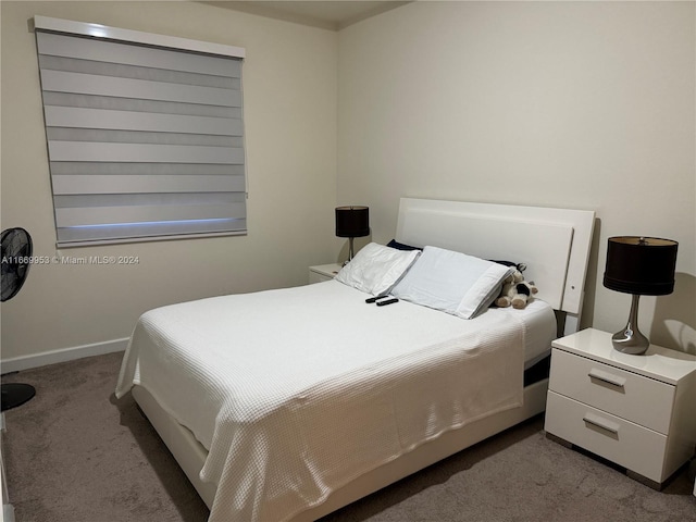 bedroom with carpet flooring and baseboards