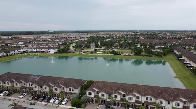drone / aerial view with a water view and a residential view