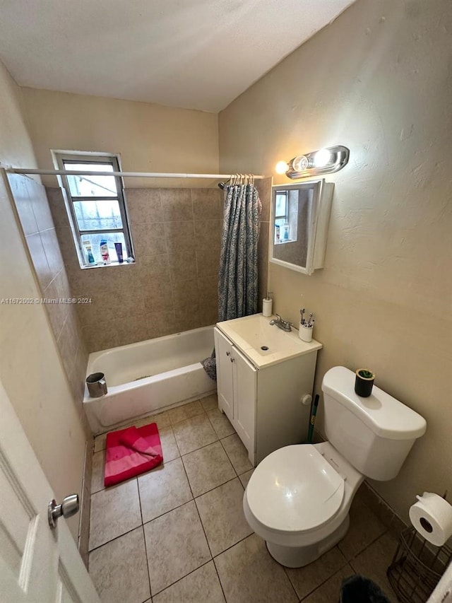 full bathroom with vanity, shower / bath combo with shower curtain, toilet, and tile patterned flooring