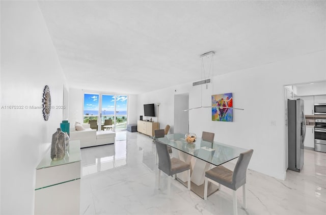 dining room with expansive windows, marble finish floor, and visible vents