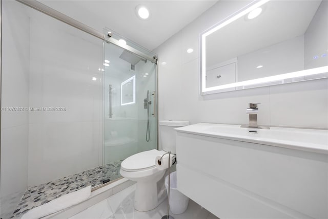 bathroom with vanity, a shower stall, toilet, and recessed lighting