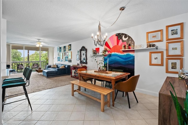 dining area featuring ceiling fan with notable chandelier, light tile patterned floors, and a textured ceiling