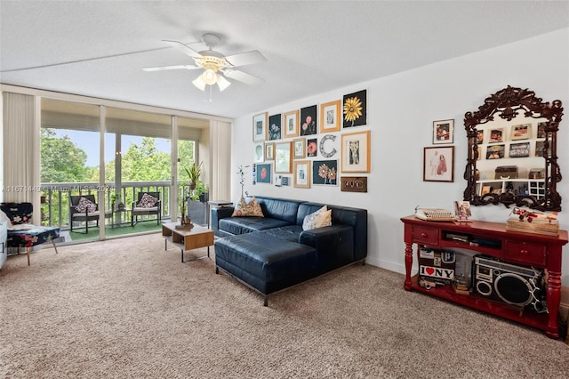 carpeted living room featuring a textured ceiling and ceiling fan