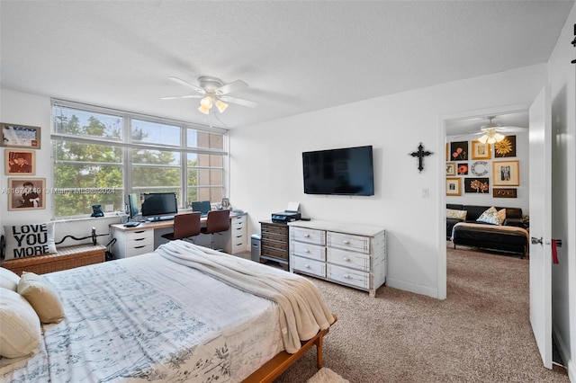 bedroom with ceiling fan, light colored carpet, and a textured ceiling