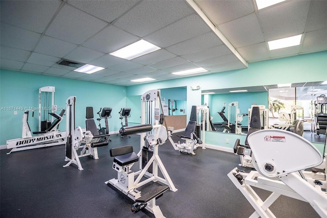 gym with a paneled ceiling