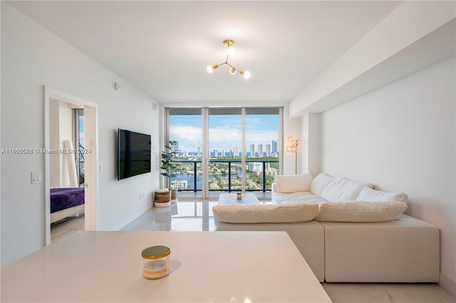 living room featuring a chandelier and expansive windows