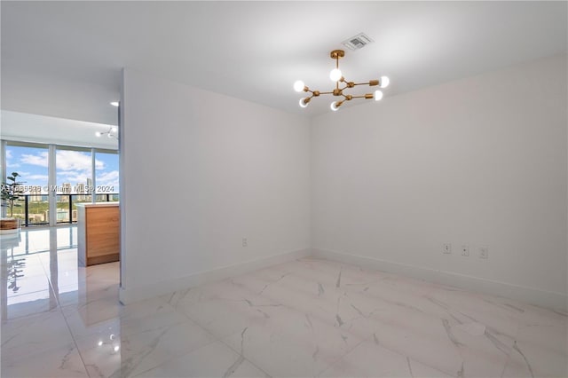 spare room with a chandelier