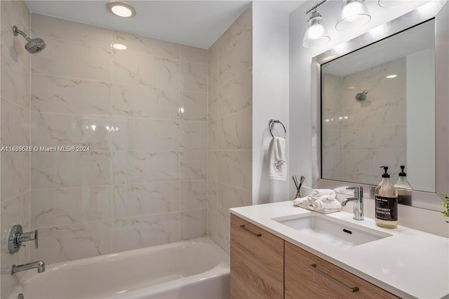 bathroom with tiled shower / bath and vanity