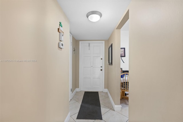 corridor featuring light tile patterned floors