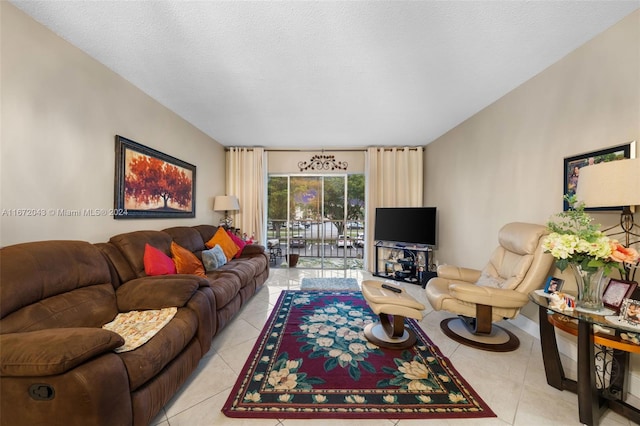 tiled living room featuring a textured ceiling