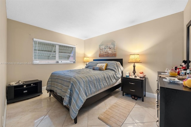 bedroom with light tile patterned floors