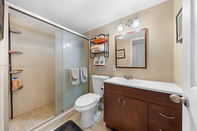 bathroom featuring vanity, tile patterned flooring, toilet, and a shower with door