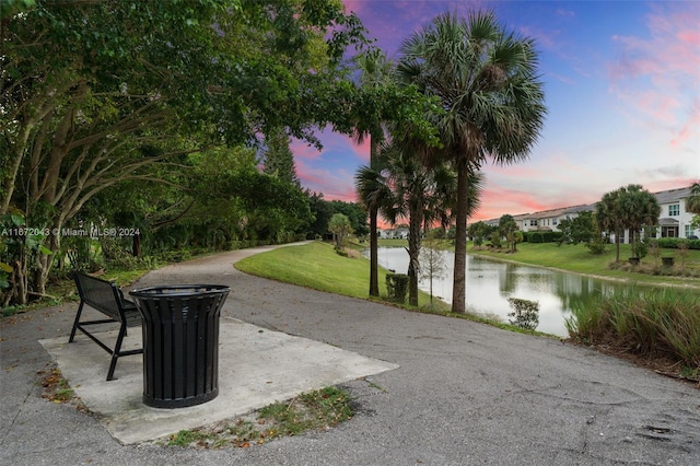 view of property's community with a yard and a water view