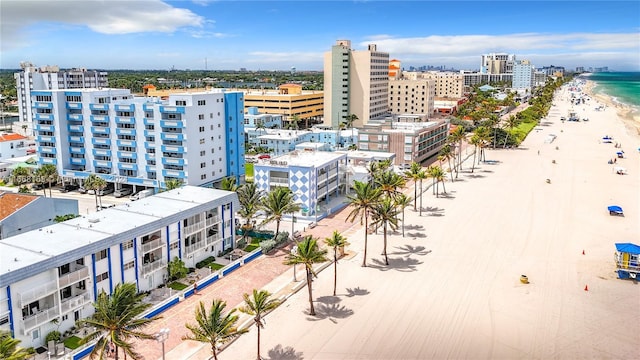 birds eye view of property with a view of the beach and a water view